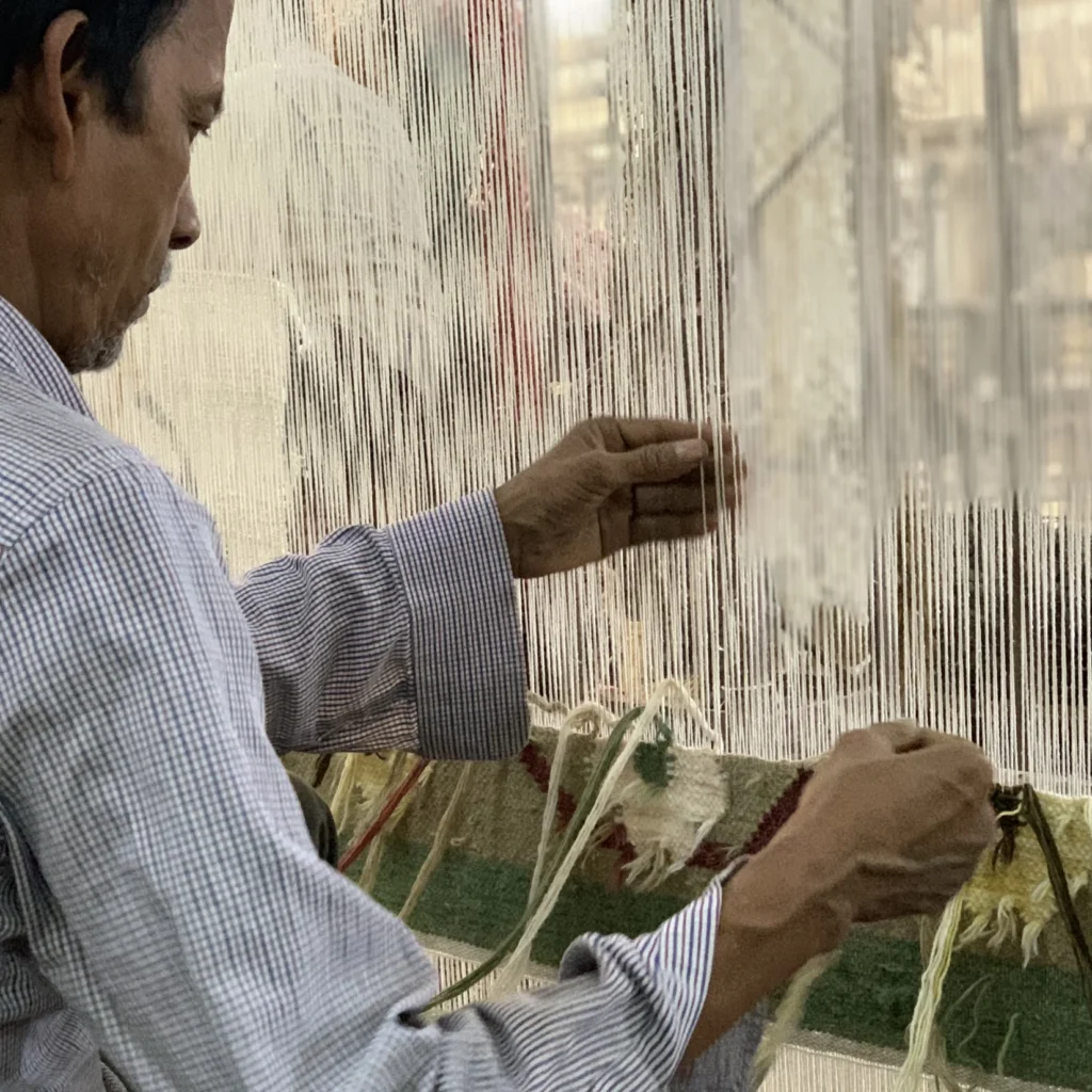 Weaver weaving a handmade Carpet for Export